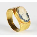 A Roman gold ring, the bezel inset with a white overlaid blue glass cameo depicting a female bust,