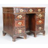An 18th century and later walnut and floral marquetry inlaid kneehole desk, the top with an oval