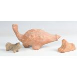 A Roman period Egyptian terracotta model of a sphinx, 1st century AD, length 7cm, together with a