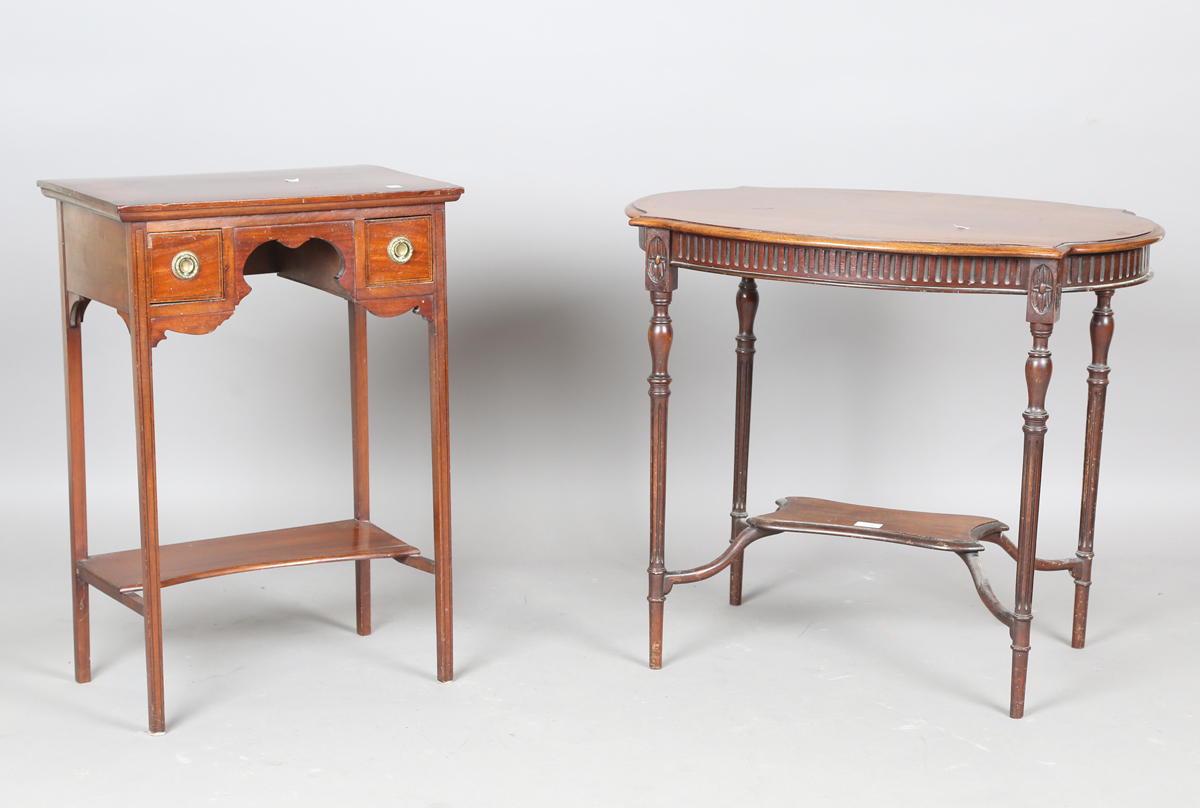 An Edwardian mahogany oval two-tier occasional table, on fluted tapering legs, height 67cm, width