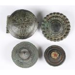 A group of four large ancient copper alloy disc and boss type brooches, including an example with