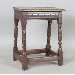 A 17th century oak joint stool, the moulded rectangular top on turned and block legs, height 54cm,