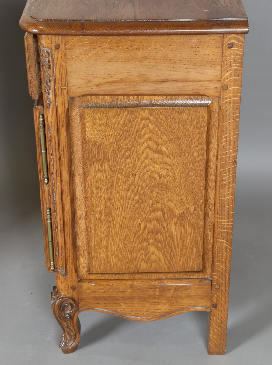 A pair of late 20th century French oak bedside cabinets, each fitted with a finely carved drawer and - Image 4 of 17