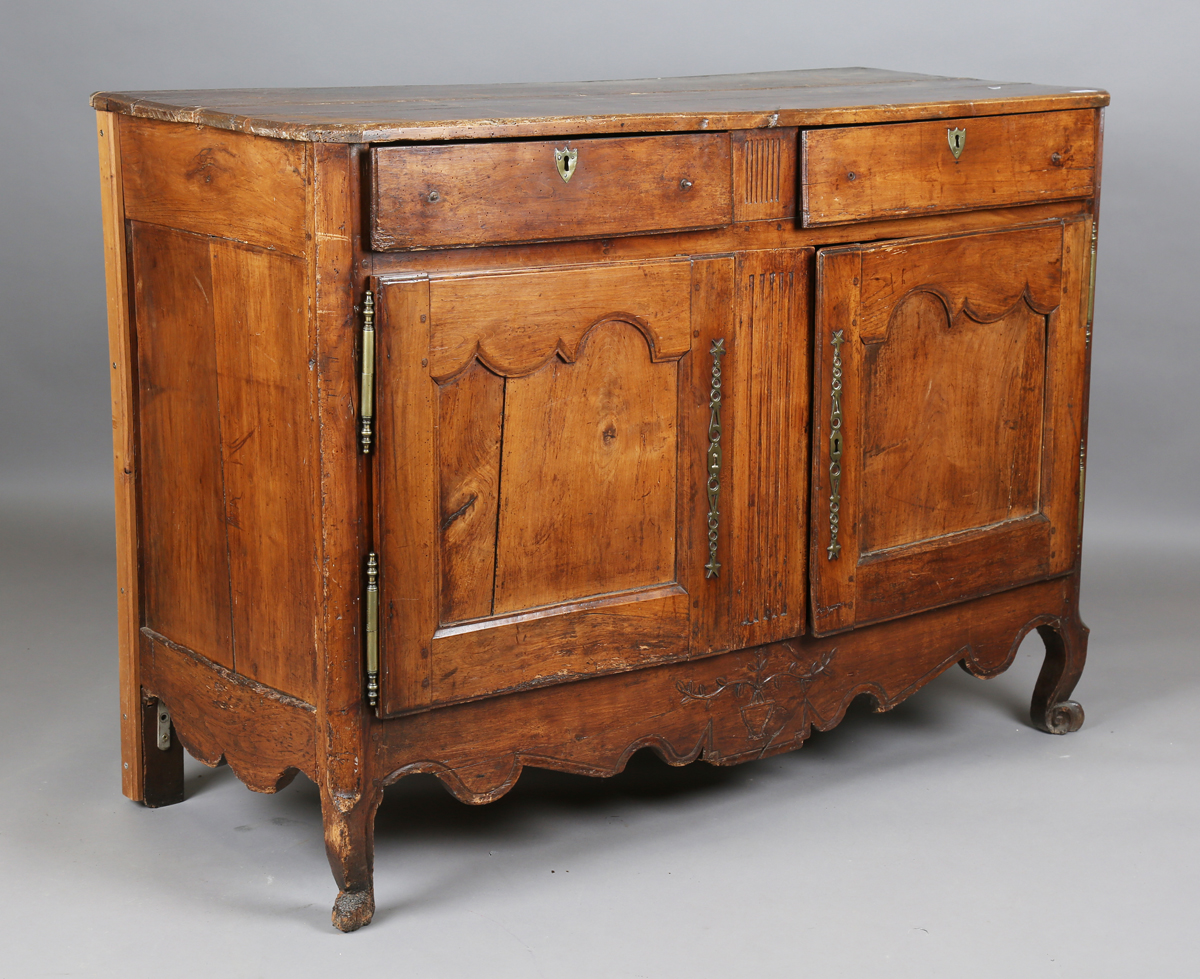 An 18th century French provincial walnut cabinet, fitted with two drawers above panelled doors,