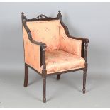 An Edwardian mahogany showframe armchair with carved leaf and beaded decoration, on fluted