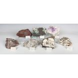 A collection of mineral specimens, including dravit, almandite, biotite mica, malachite on