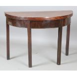 An early 19th century mahogany demi-lune fold-over tea table, raised on block legs, height 76cm,