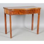 A George III mahogany serpentine front fold-over tea table, height 72cm, width 90cm, depth 44cm.