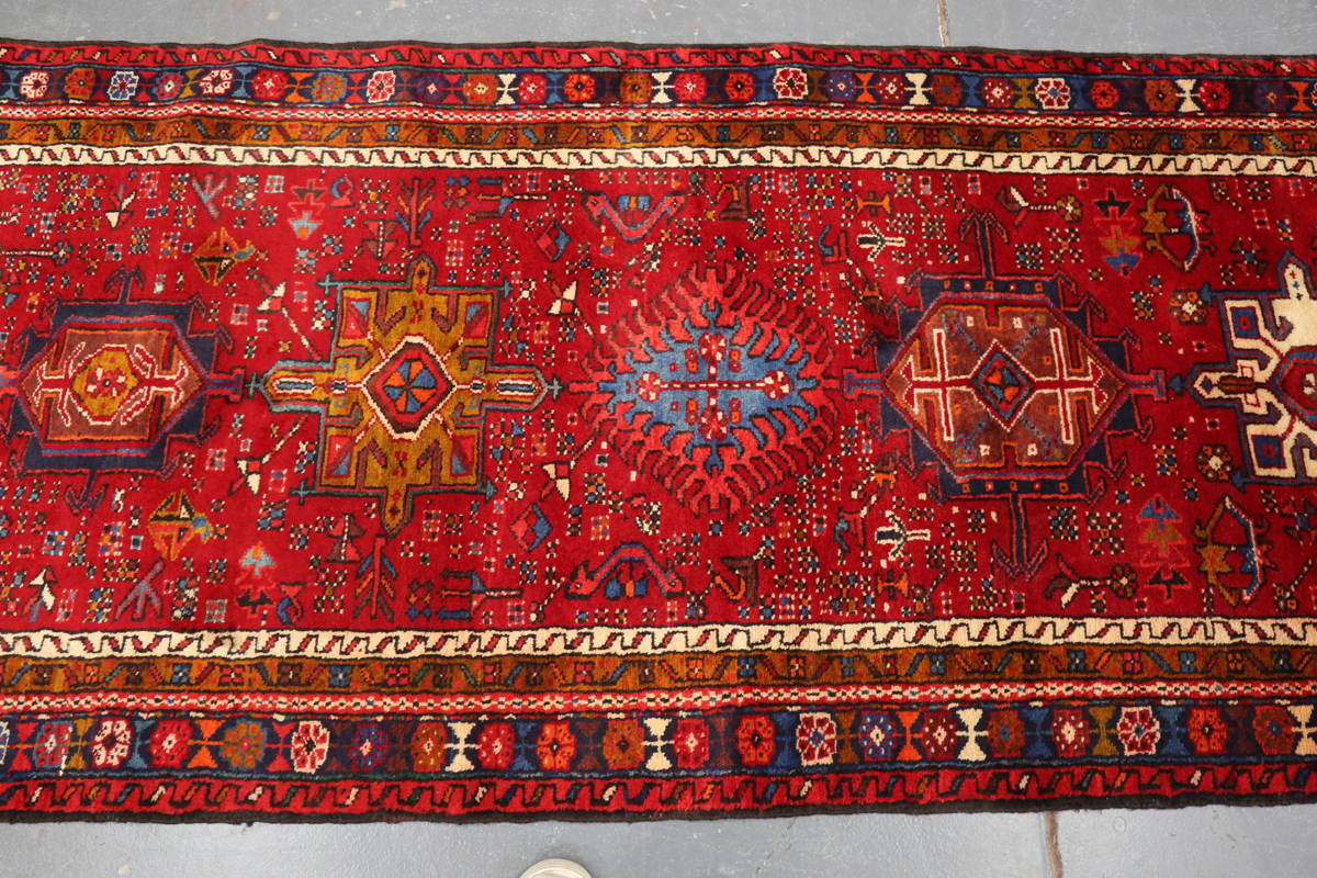 A Heriz runner, North-west Persia, mid/late 20th century, the red field with a column of shaped - Image 6 of 7