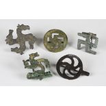 A group of five various Roman copper alloy brooches, comprising two fylfot designs, a disc whorl and