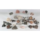 A collection of mineral specimens, including tonalite, kentallenite with brown mica, ankaranite