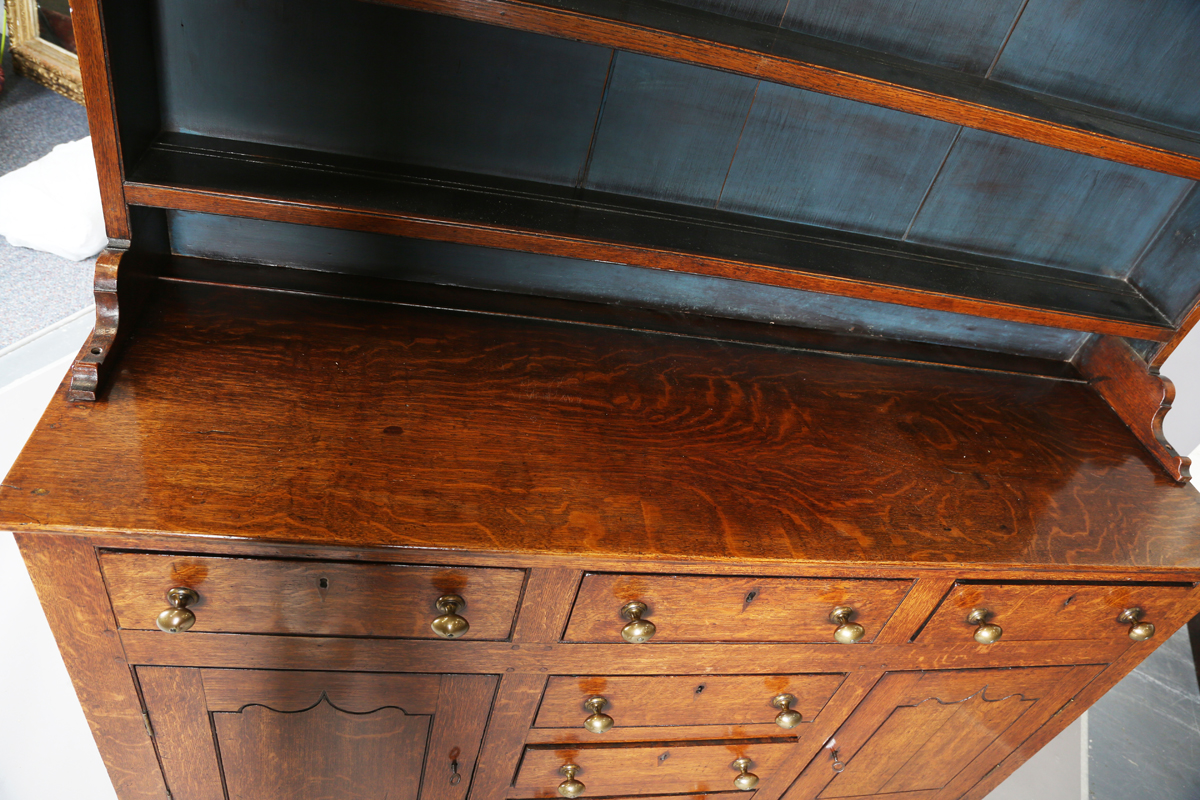 A late George III provincial oak dresser, the shelf back with blue painted backboards, the base with - Image 8 of 9