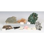 A collection of mineral specimens, including desert rose, various barytes, tiger's eye, uvarovite,