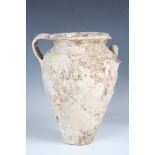 An ancient ocean-found terracotta amphora, the ovoid twin-handled body covered in a thick layer of
