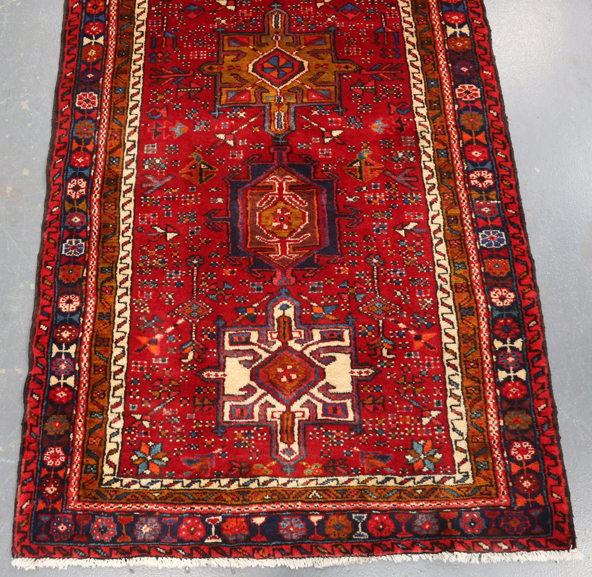 A Heriz runner, North-west Persia, mid/late 20th century, the red field with a column of shaped
