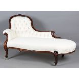 A mid-Victorian walnut showframe chaise longue, upholstered in modern foliate patterned cream