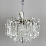 A mid-20th century Austrian ice glass three-tier eighteen-light chandelier by Kalmar, the nickel