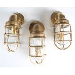 Three modern brass bulkhead style lanterns, height 30cm.Buyer’s Premium 29.4% (including VAT @