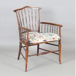 An early 20th century Arts and Crafts stick back elbow chair with a caned seat, height 83cm, width
