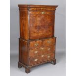 A Queen Anne and later walnut escritoire, the period top with a cushion frieze drawer and fall flap,