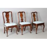 A group of three Queen Anne provincial vase back dining chairs, comprising two walnut examples and
