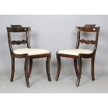 A pair of Regency stained walnut and brass inlaid bar back dining chairs with drop-in seats,
