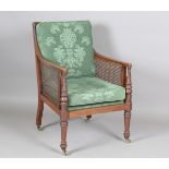 A late 19th century Regency style mahogany framed bergère library armchair, height 94cm, width 58cm,