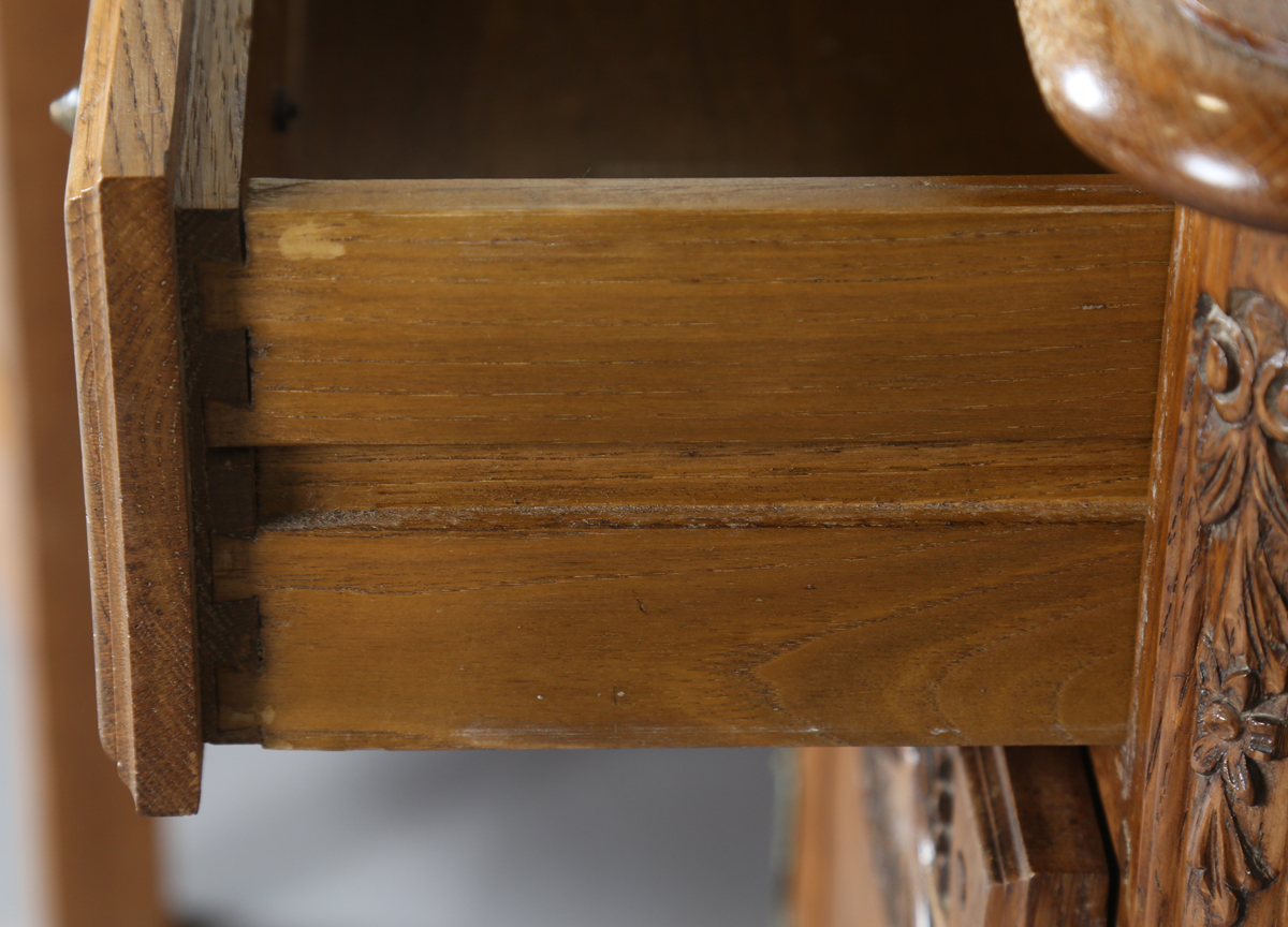 A pair of late 20th century French oak bedside cabinets, each fitted with a finely carved drawer and - Image 8 of 17