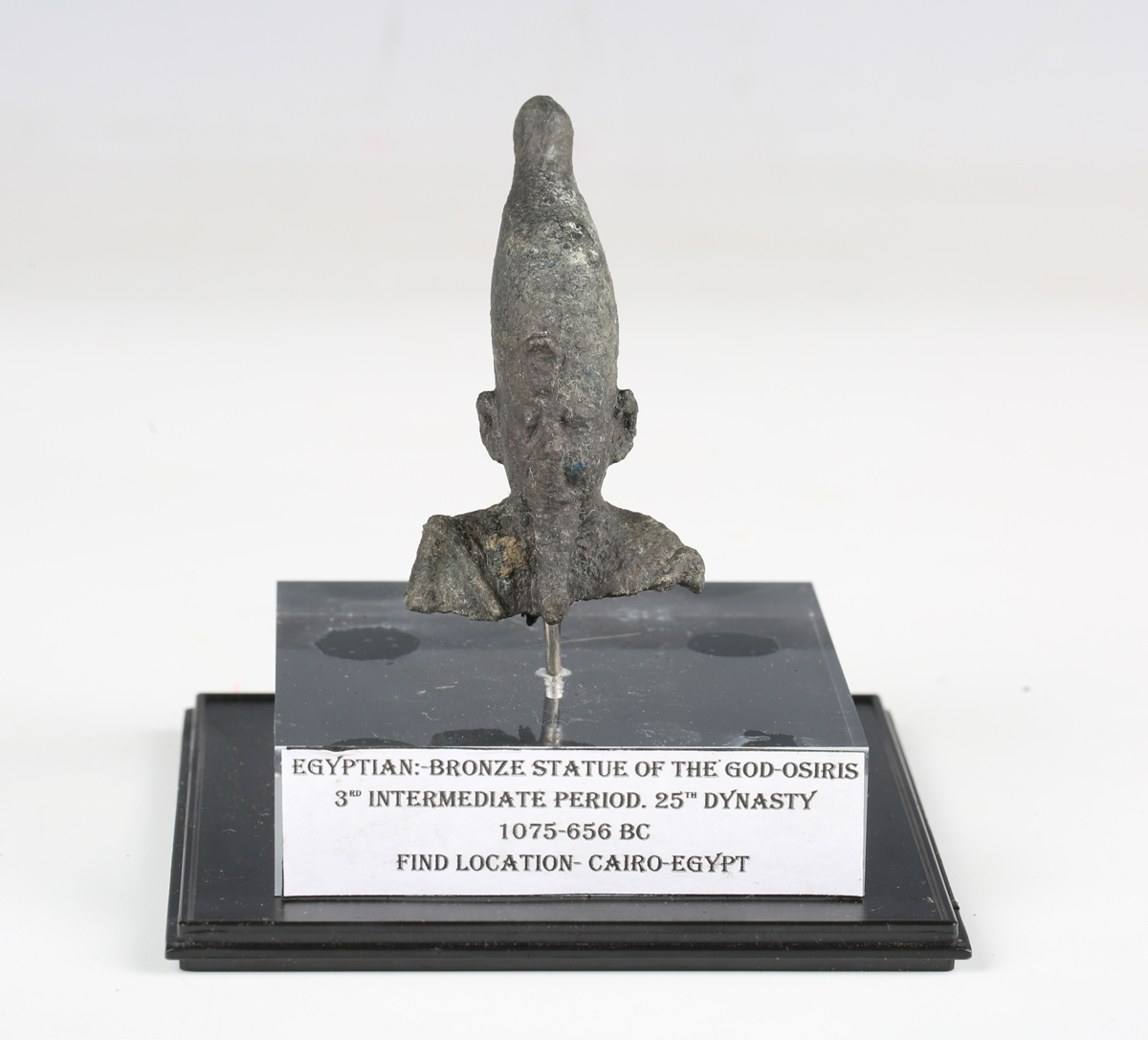 An Egyptian bronze head and shoulders bust of Osiris, height 6.5cm, mounted within a detailed