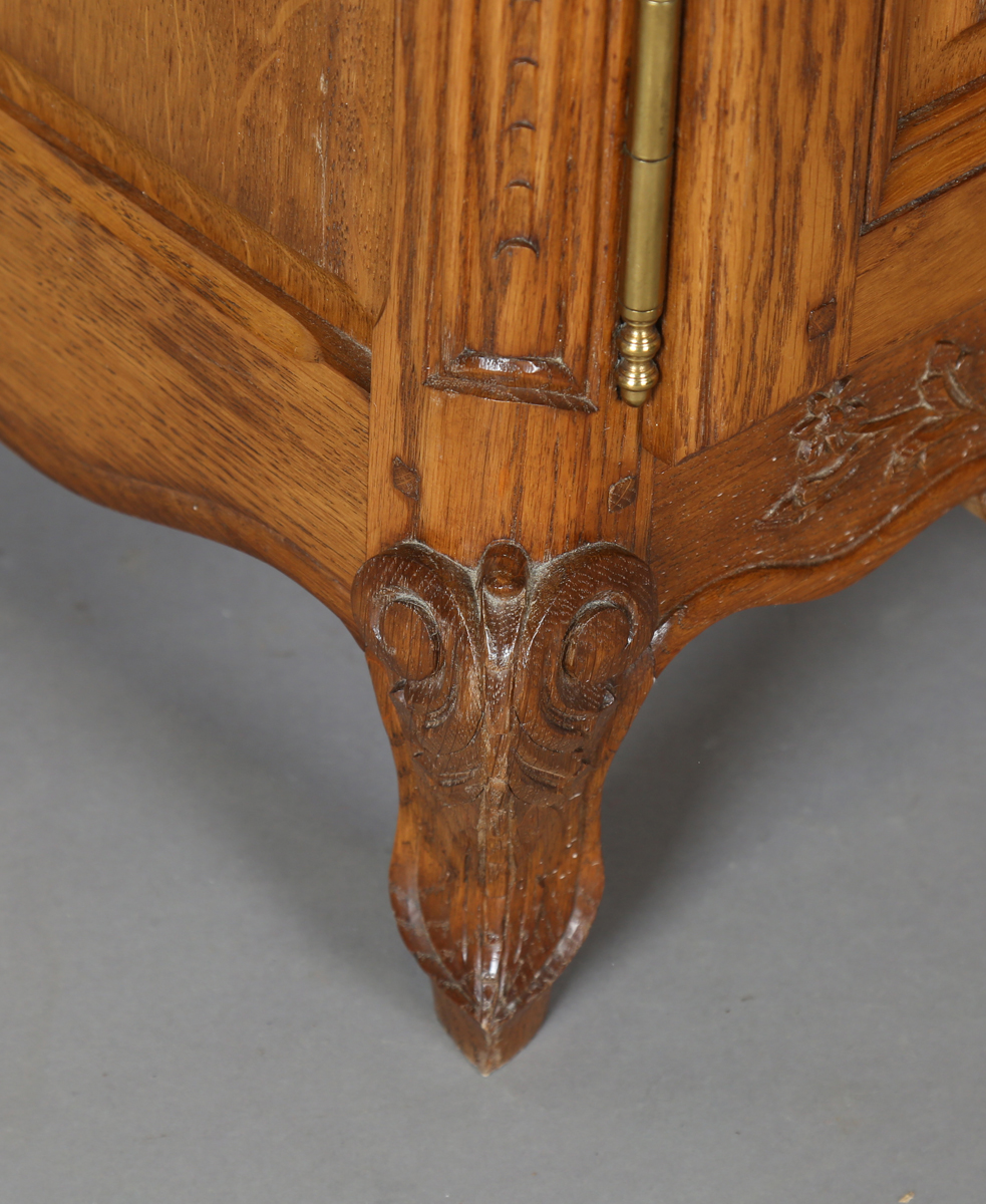 A pair of late 20th century French oak bedside cabinets, each fitted with a finely carved drawer and - Image 14 of 17