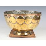 A 19th century brass bowl, decorated with a band of roundels, diameter 31cm, together with 19th