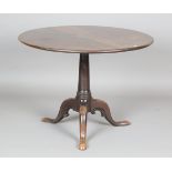 A George III mahogany circular tip-top supper table, raised on carved tripod legs, height 68cm,