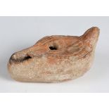 A Byzantine terracotta oil lamp, the top decorated in relief with a Chi Rho, length 9.5cm.Buyer’s