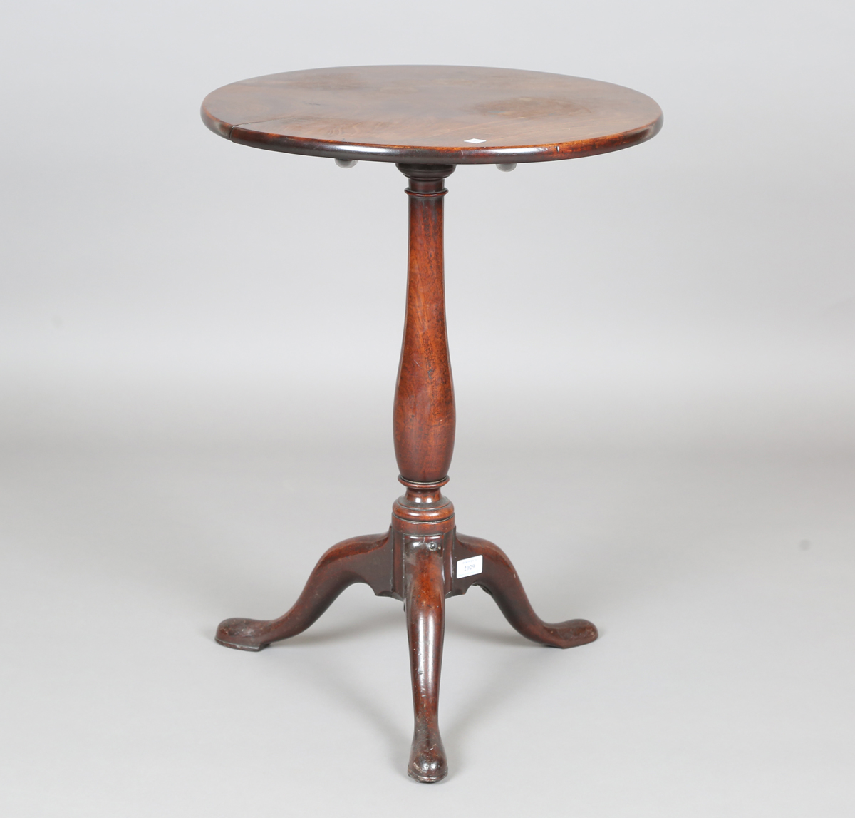 A George III mahogany circular tip-top wine table, raised on tripod legs, height 69cm, diameter