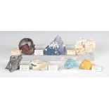 A collection of mineral specimens, including polished agate slices, rock crystal, selenite,