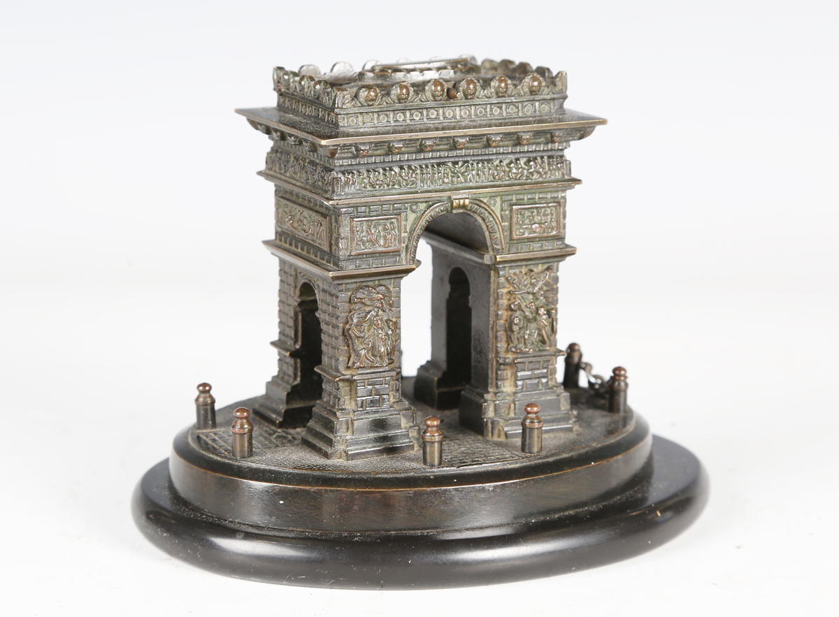 A late 19th/early 20th century brown patinated cast bronze model of the Arc de Triomphe, raised on