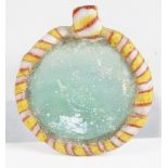 An ancient glass circular pendant, possibly Phoenician, the translucent pale blue centre with a