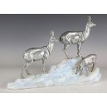 An Art Deco silvered metal ibex group, mounted upon a naturalistic Sabino type vaseline glass