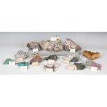 A collection of mineral specimens, including tourmaline and quartz, mesolite, hematite, calcite with