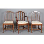 A set of seven George III Sheraton period provincial mahogany dining chairs, comprising six