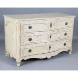 An 18th century French cream painted walnut serpentine fronted three-drawer commode, on carved squat