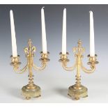 A pair of 20th century gilt metal two-branch candelabra of Empire design, each raised on a