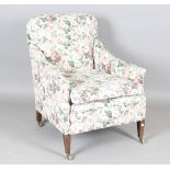 A George V armchair, upholstered in Sanderson floral cotton, on square tapering legs and brass