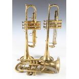 A Conn brass '52 B' trumpet, serial number '709295', cased, a Boosey trumpet, a Lark cornet and a