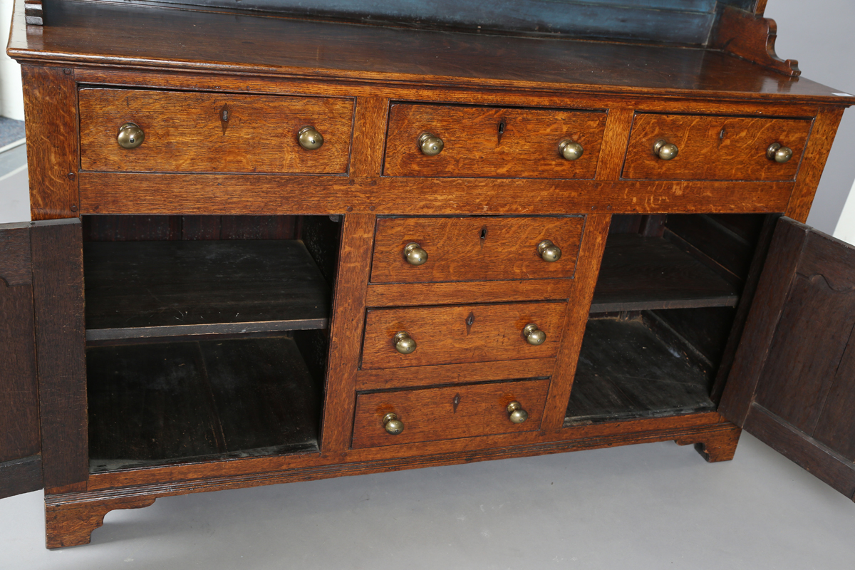 A late George III provincial oak dresser, the shelf back with blue painted backboards, the base with - Image 6 of 9