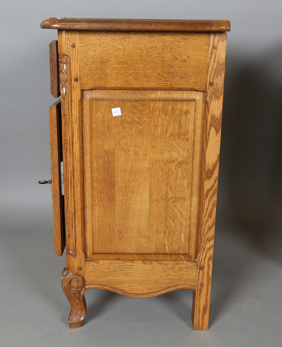 A pair of late 20th century French oak bedside cabinets, each fitted with a finely carved drawer and - Image 11 of 17