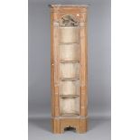 A late 19th century Neoclassical Revival narrow pine barrel-back corner shelf, the arched niche with
