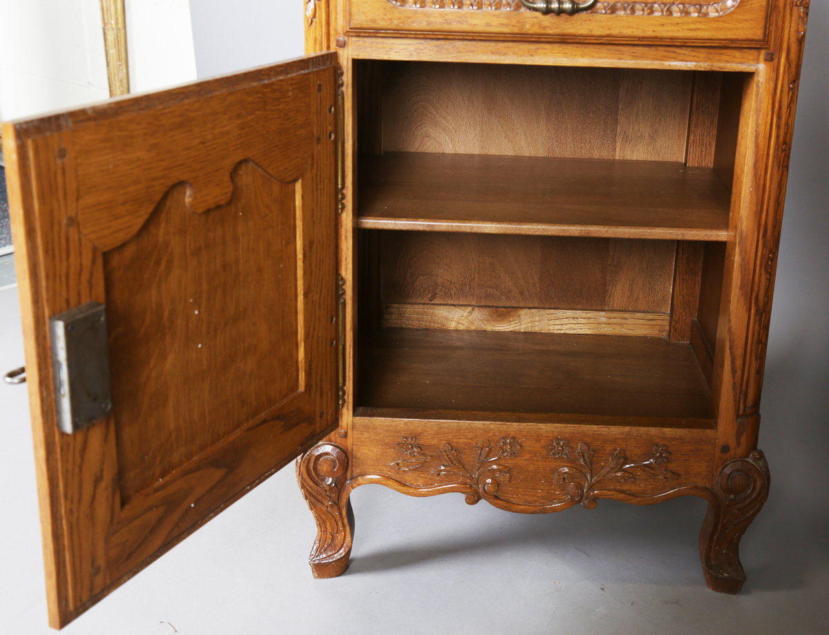 A pair of late 20th century French oak bedside cabinets, each fitted with a finely carved drawer and - Image 15 of 17