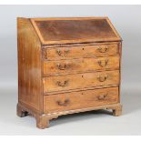 A George III flame mahogany bureau with overall satin birch crossbanding, the fall flap enclosing