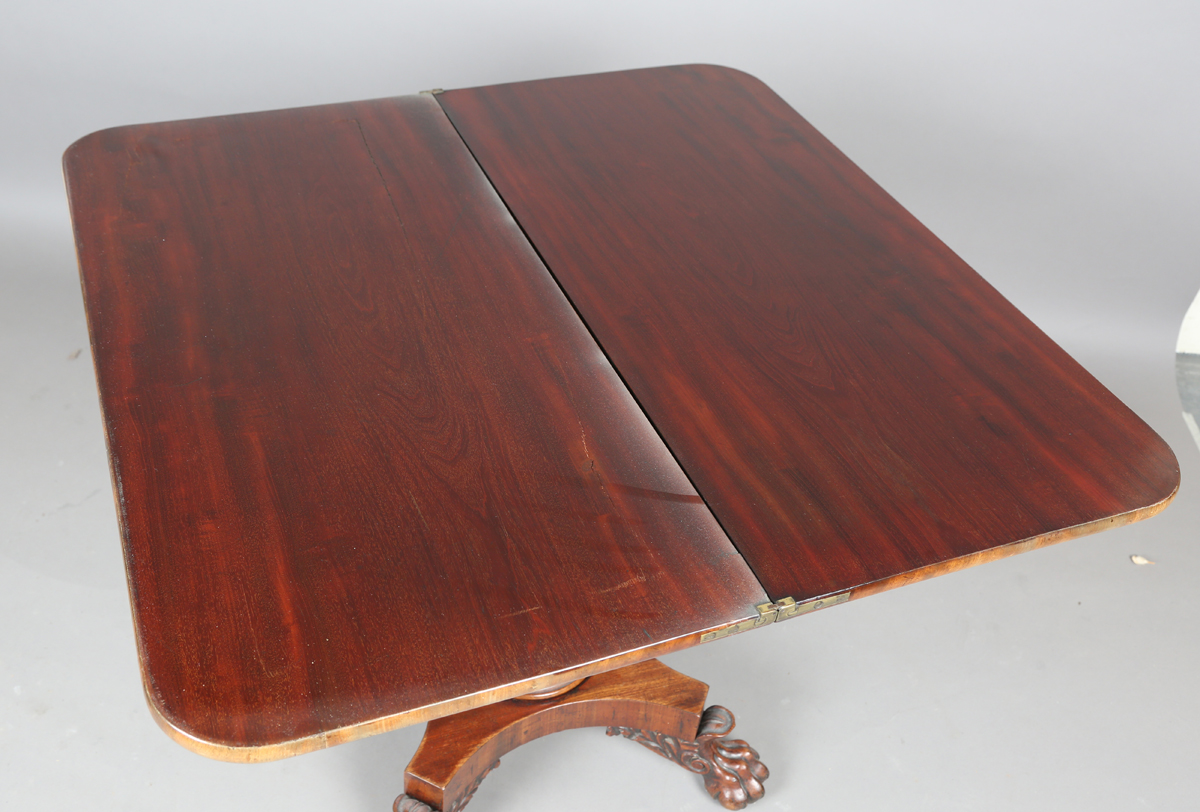 A George IV mahogany fold-over tea table, raised on a turned column and quatrefoil base, height - Image 8 of 9